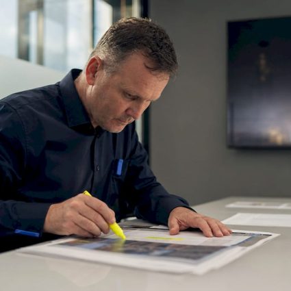 Engineer reviewing infrastructure risk documents