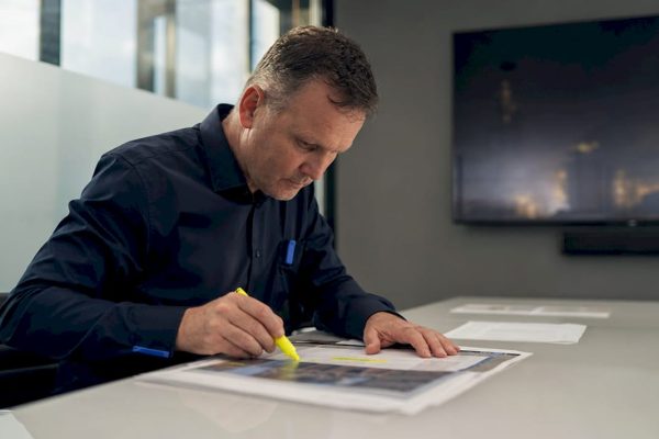Engineer reviewing infrastructure risk documents