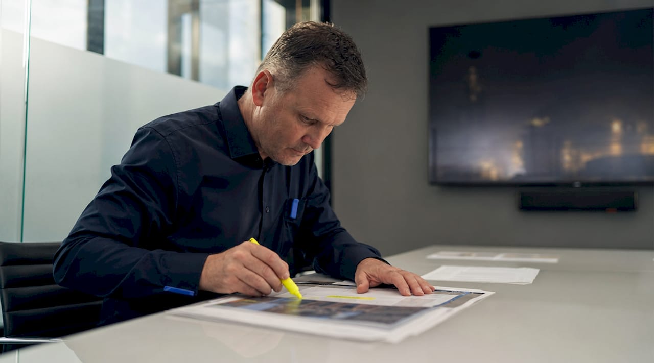 Engineer reviewing infrastructure risk documents