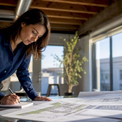 Architect reviewing protective design blueprints