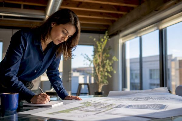 Architect reviewing protective design blueprints