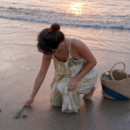 Person barefoot touching grass outdoors