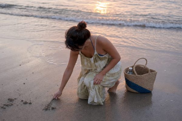 Person barefoot touching grass outdoors