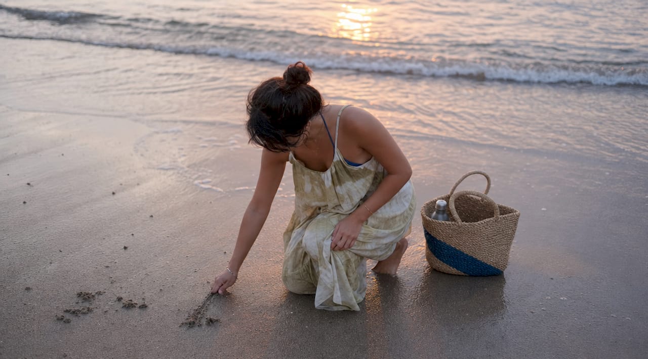 Person barefoot touching grass outdoors