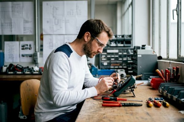 Un ingénieur procède à des essais sur un dispositif de protection contre la foudre dans son atelier.