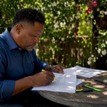 Technician reviewing lightning protection plans and certifications
