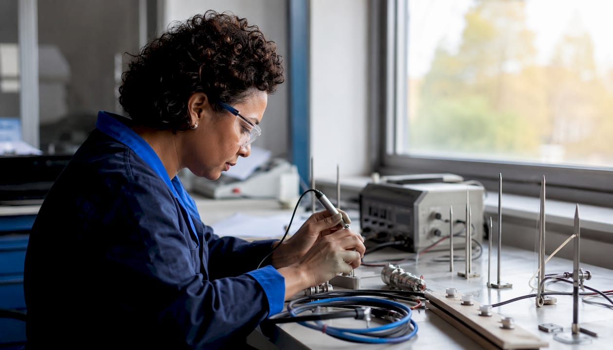 Technician calibrating lightning protection equipment in lab