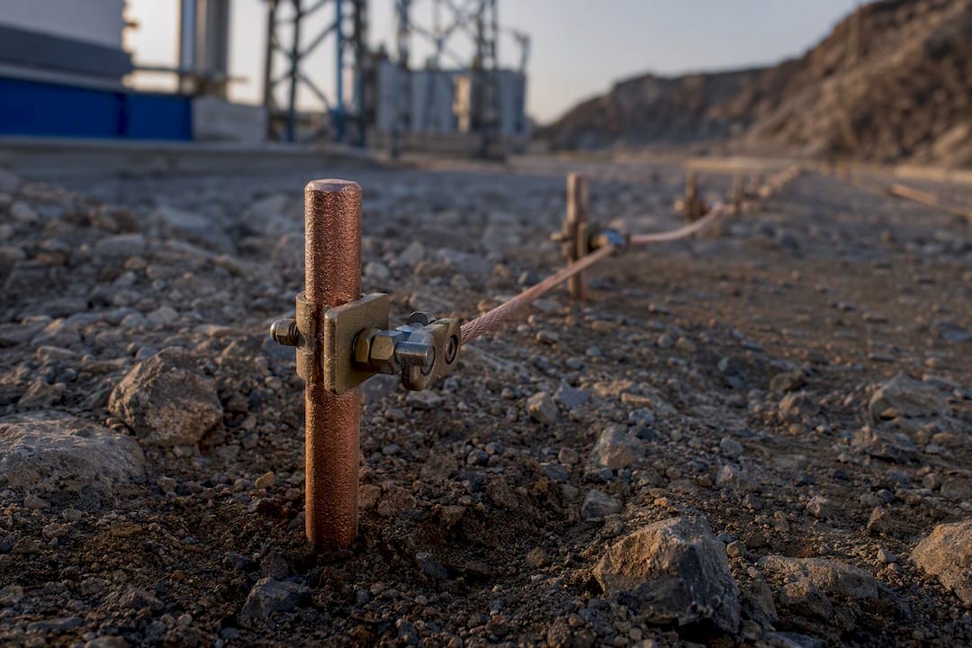 Grounding electrode and clamps in industrial soil