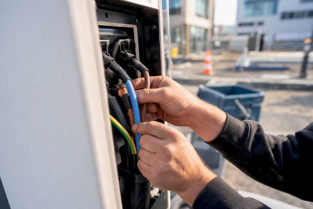 Electrician connecting EV charger cable