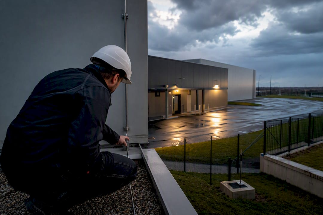 Technician inspecting industrial lightning protection system