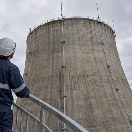 Technician inspecting cooling tower lightning protection