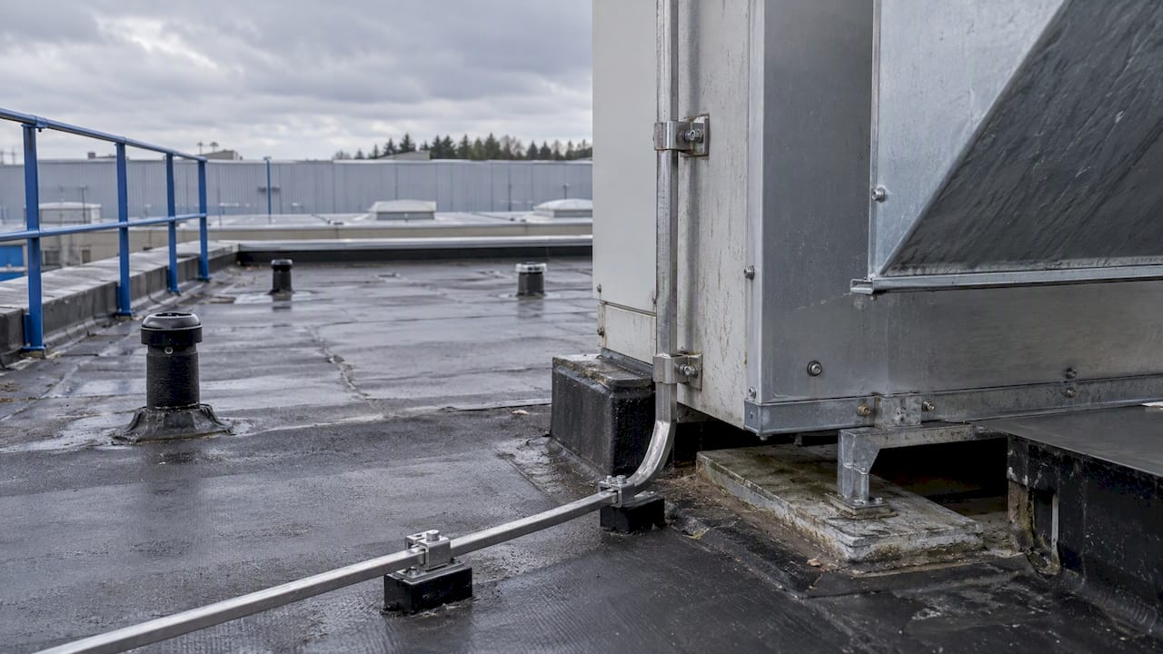 Down-conductor separated from nearby rooftop metalwork