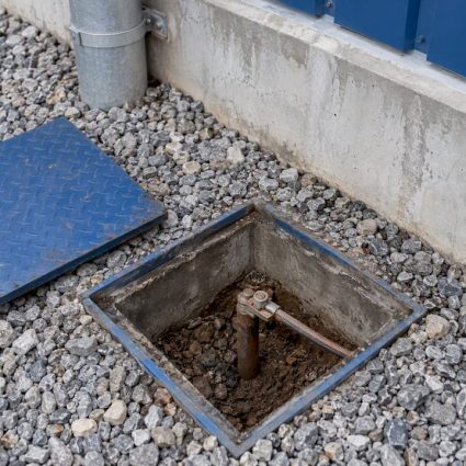 Earthing electrode access pit beside facility