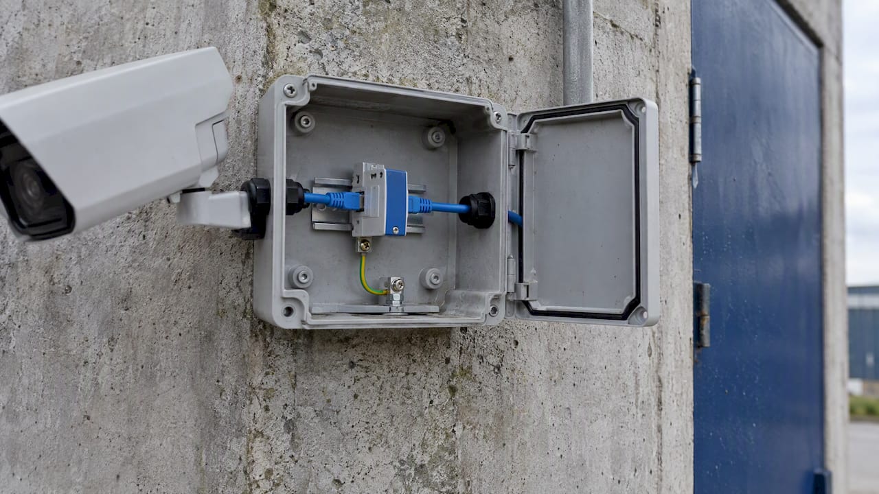 Data-line surge protector inside an outdoor enclosure